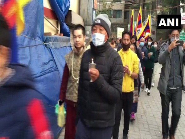 Tibetan activists held a candlelight vigil in Dharamshala over the custodial death of a Tibetan in China (ANI)
