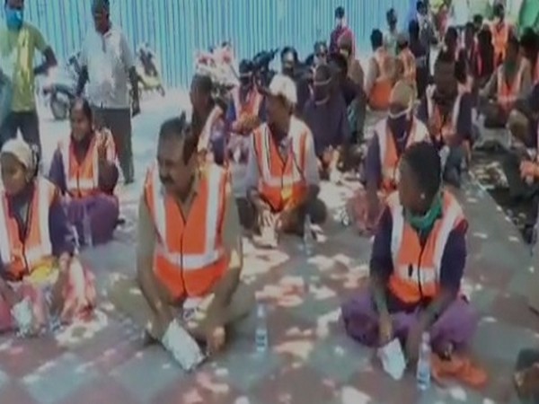 Sanitation workers at the Annarao circle area in Tirupati. Photo/ANI