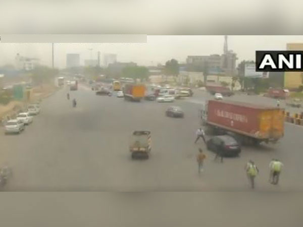 A video grab of CCTV footage of the car which drove away with toll plaza employee on car's bonnet. (Photo/ ANI)