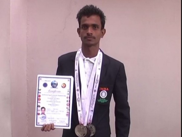 Toran Yadav with his medals and certificate.