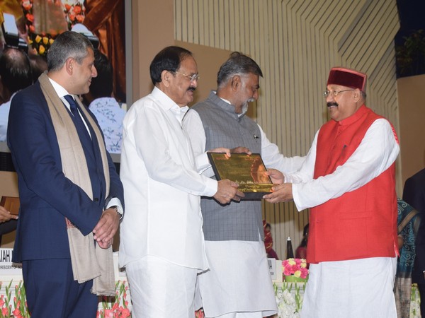 Vice President Venkaiah Naidu awarding Uttarakhand's tourism minister Satpal Maharaj at the Vigyan Bhawan on Friday. 