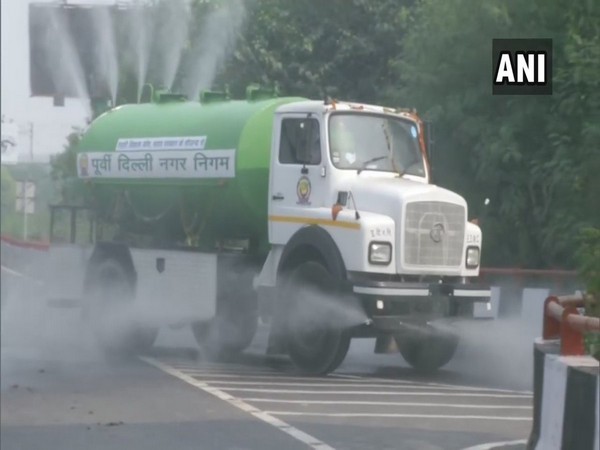 EDMC sprinkles water on roads in Lakshmi Nagar [Photo/ANI]