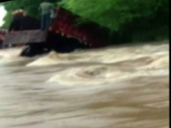 Truck carrying girl students skids off due to overflowing stream in Dungarpur, Rajasthan on Saturday. 