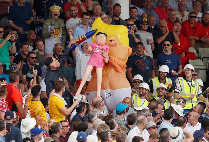 A man dressed as the Trump baby blimp holding a Kim Jong-un dummy at the first Ashes Test on Aug 3 in Edgbaston (Photo/Reuters)