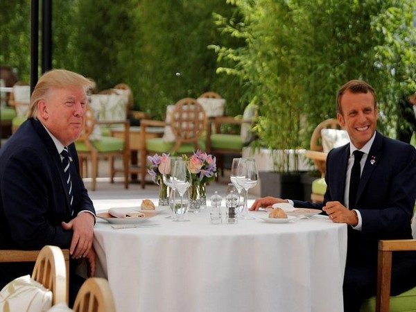 US President Donald Trump (L) with French President Emmanuel Macron (R) at a lunch meeting in Biarritz on Saturday ahead of the G7 Summit (Photo/Reuters)