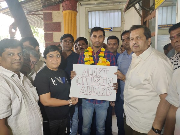 Uber driver Rohit Singh (holding placard) with Mangal Prabhat Lodha (right)