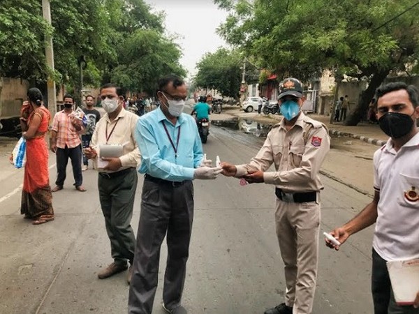 Pharma Synth company representative distributing sanitizers to police
