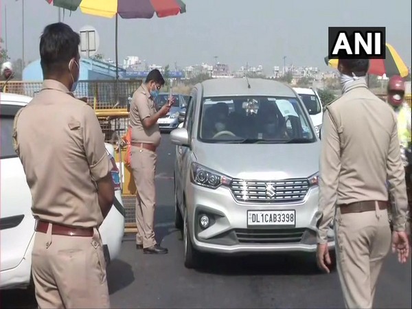 Police personnel are checking IDs and passes of people as they commute through the Delhi-Ghazipur border. (Photo/ANI)