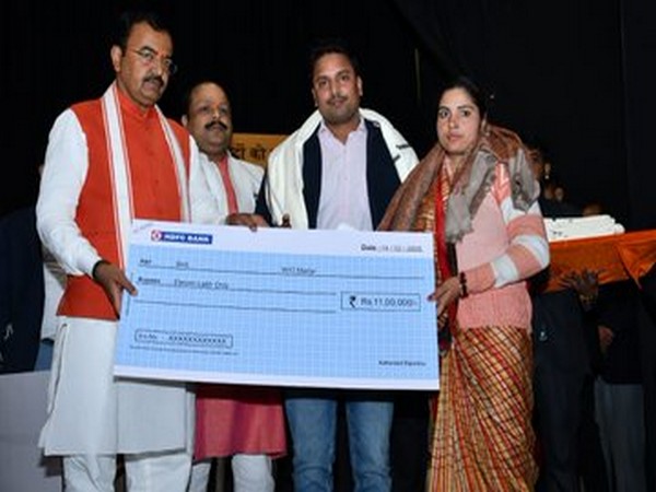 Visuals of Keshav Prasad Maurya giving cheque to wife of a CRPF personnel, who was killed in Pulwama attack last year. Photo: Twitter@kpmaurya1