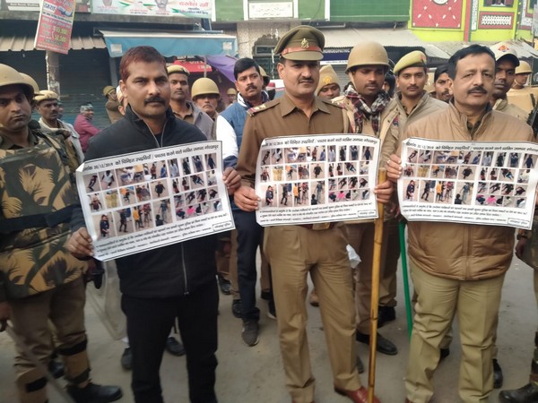 Uttar Pradesh police officials with photographs of stone pelters in Gorakhpur on Saturday. 