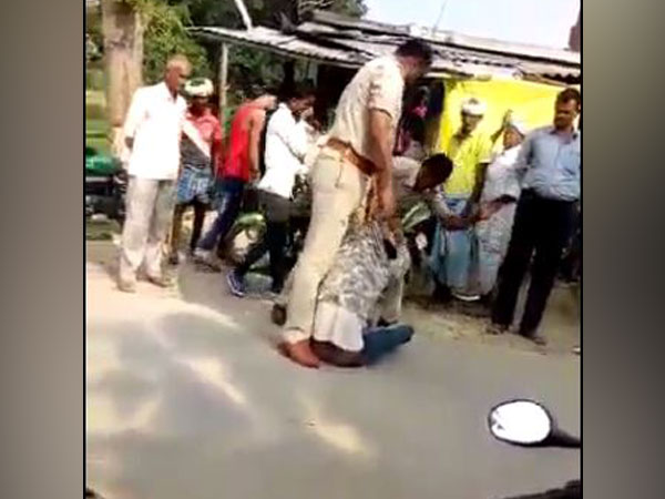 Visuals from the viral video in which two police personnel can be seen thrashing a man in Uttar Pradesh's Siddharthnagar district (Photo/ANI)