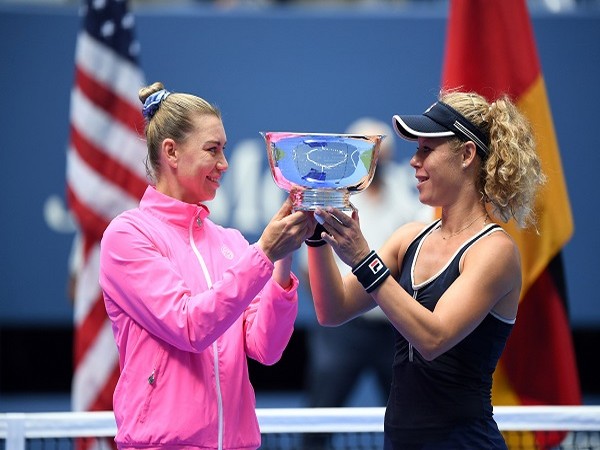 Vera Zvonareva of Russia and Laura Siegemund of Germany hold the championship trophy.