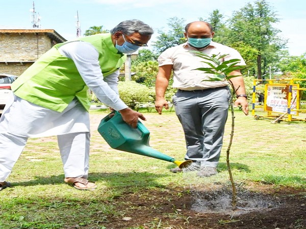 Uttarakhand CM plants tree at his residence to celebrate World Environment Day. (Photo/ANI)