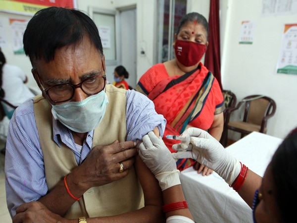 A beneficiary receives a dose of covishield covid-19 vaccine at an auditorium. (Photo/ANI)