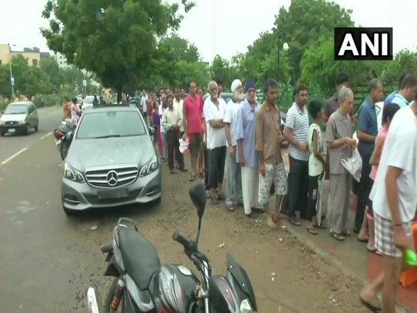 Many people in the city were seen queuing outside shops to buy essentials after two days of heavy rain in the Vadodara. Photo/ANI