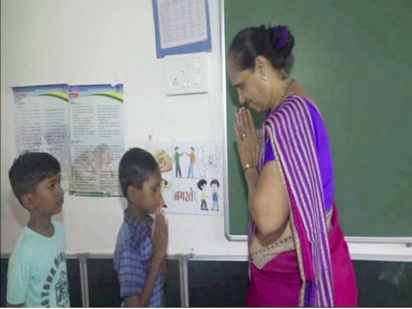 Teacher welcoming students in the classroom under Bal Satkar program in Vadodara. Photo/ANI