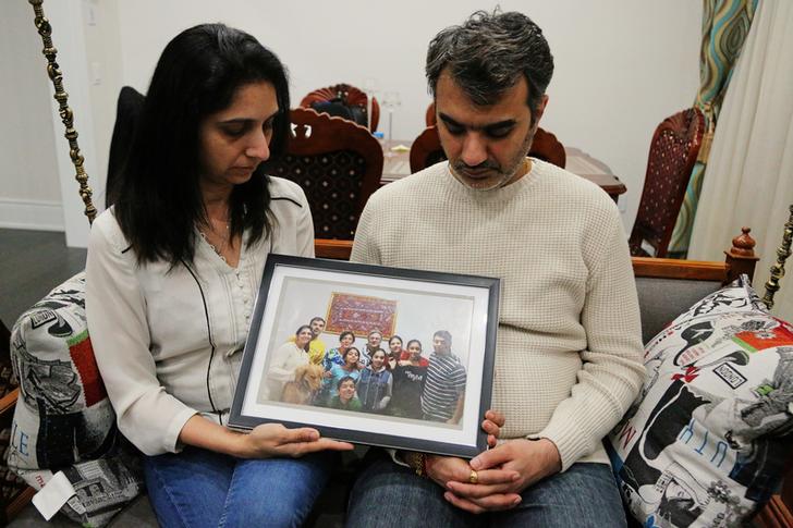 The Vaidyas holding a family portrait at their home in Brampton, Canada, after the devastating Ethiopian Airlines crash. (Photo/ Reuters)
