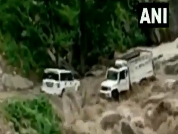 A visual of submerged vehicles in overflowing stream at JK's Kishtwar. (Photo/ANI)