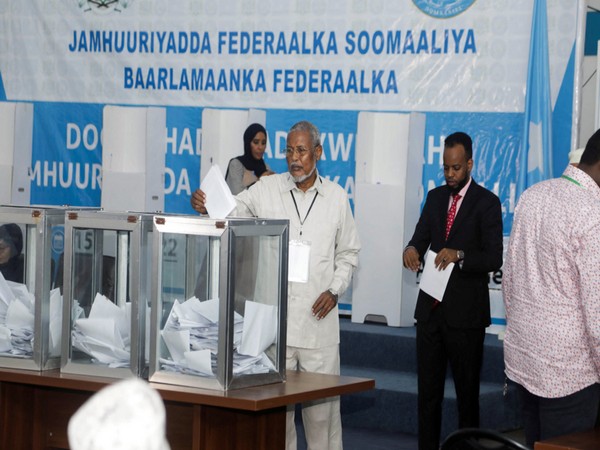 A member of the Somali parliament casts a ballot during the first round of the Somali presidential elections, in Mogadishu, Somalia (Photo Credit: Reuters)