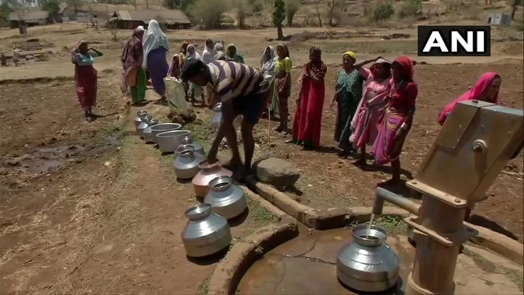 Villagers wait in queue at a handpump near Mal village to fetch water.