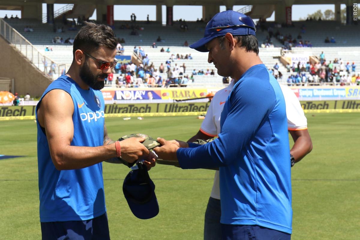 MS Dhoni presents a camouflage cap to Virat Kohli (Courtesy- BCCI)