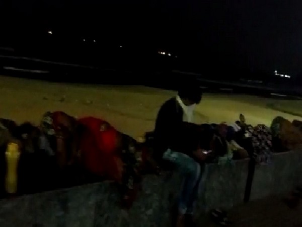 Visuals of people spending the night on footpath on a road at Ramakrishna Beach in Visakhapatnam, Andhra Pradesh. Photo/ANI