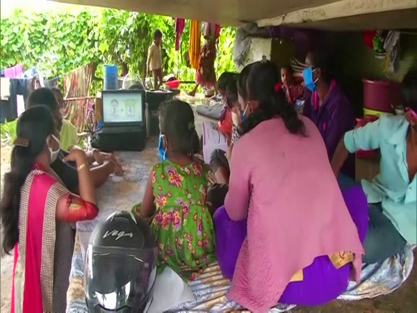Students gather around a laptop under the the Bolgatty-Vallarpadam Bridge in Kochi. Photo/ANI