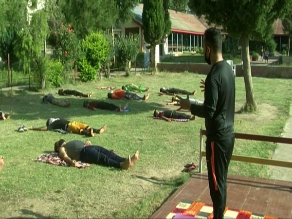 Quarantined people practice Yoga in Doda, Jammu and Kashmir. 