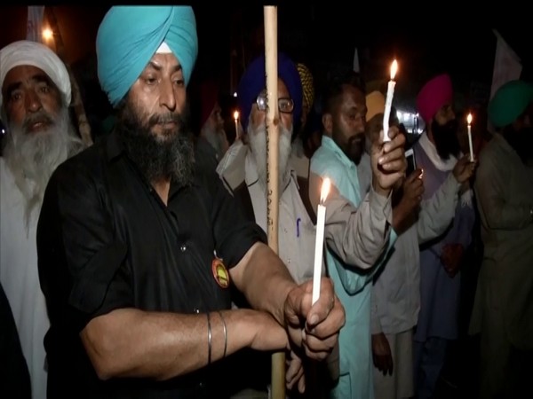 People hold candle march at Singhu border to mark the second anniversary of the Pulwama attack. (Photo/ANI)