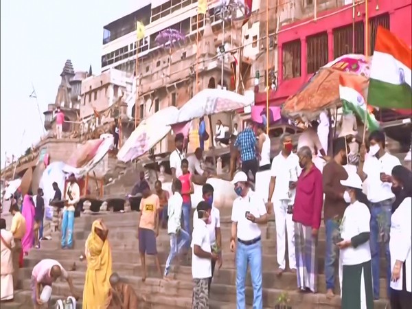 Volunteers hand out plants. (Photo/ANI)