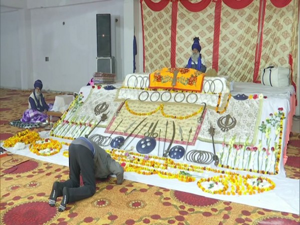A protestor praying at the temporary Gurudwara at the Singhu border. (Photo/ANI)