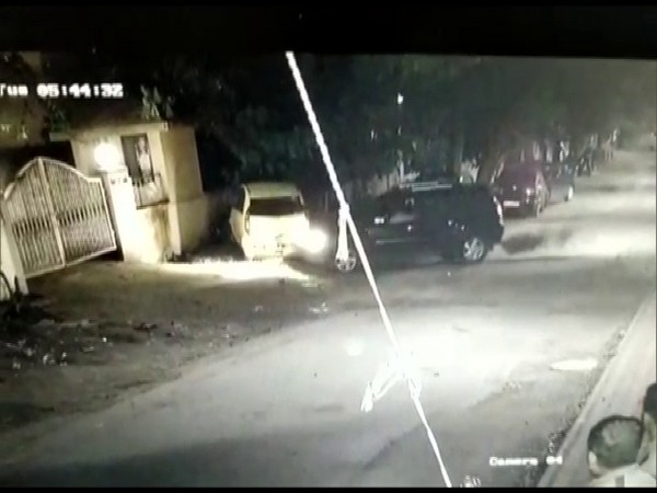 screenshot from a CCTV footage where a woman is seen damaging the other car