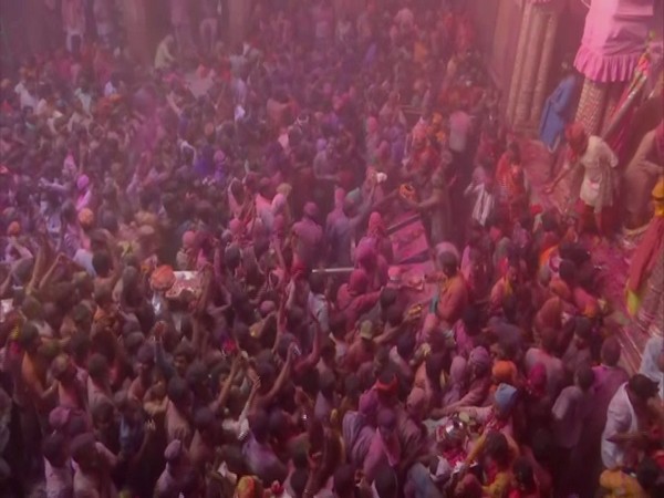 Priests at the temple were seen playfully throwing colours on devotees at Banke Bihari Temple in Vrindavan. (Photo/ANI)