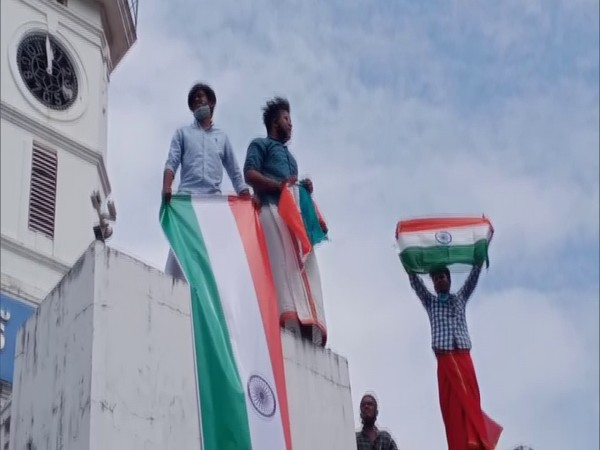 DYFI workers raising the national flag atop the Palakkad Municipality Building. (Photo/ANI)
