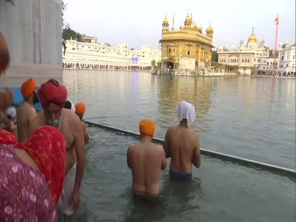 Devotees took a holy dip in the sarovar at Golden Temple in Amritsar. (Photo/ANI)