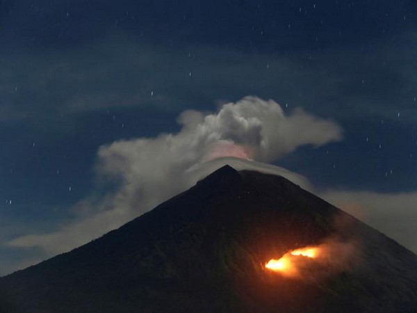 Fire is seen on the slopes of Mount Agung volcano following an eruption on Friday