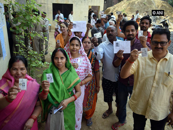 Voters waiting for their turn at a polling booth in Uttar Pradesh on Sunday. (Photo/ANI)