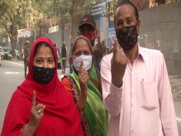 Voters outside a polling booth in Trilokpuri ward of Delhi. (Photo/ANI)