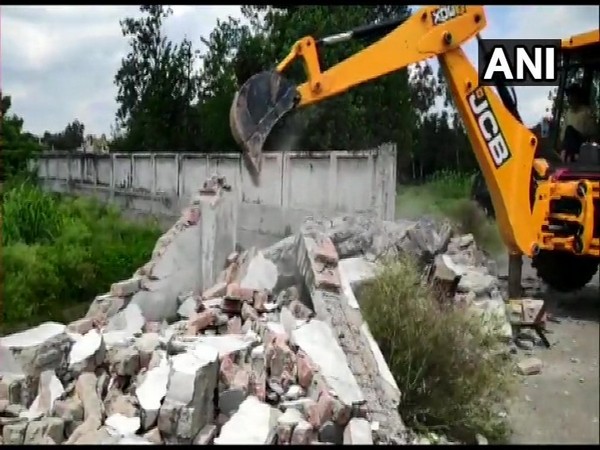 Boundary wall of 'Humsfar' resort belonging to Abdullah Azam Khan being demolished in Rampur on Friday.