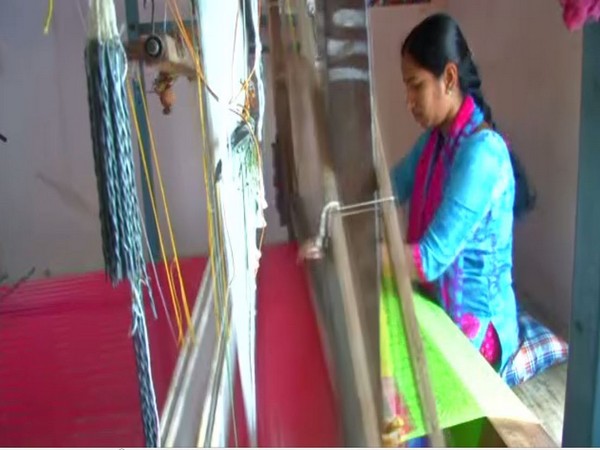 A lady weaving a cloth at a handloom in Coimbatore [Photo/ANI]