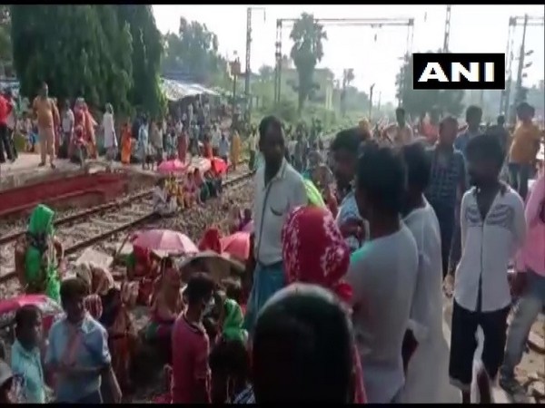 Passengers demanding to board trains operating for essential purposes block railway track in Pandua, West Bengal. (Photo/ANI)
