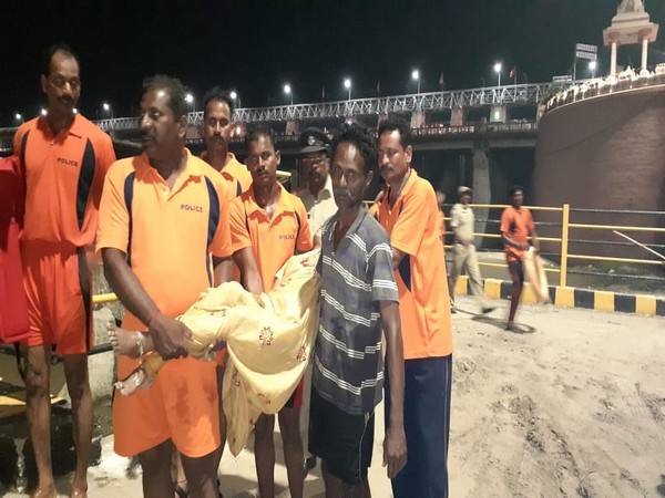 Rescue personnel carry the body of a woman who allegedly committed suicide in Vijayawada. 