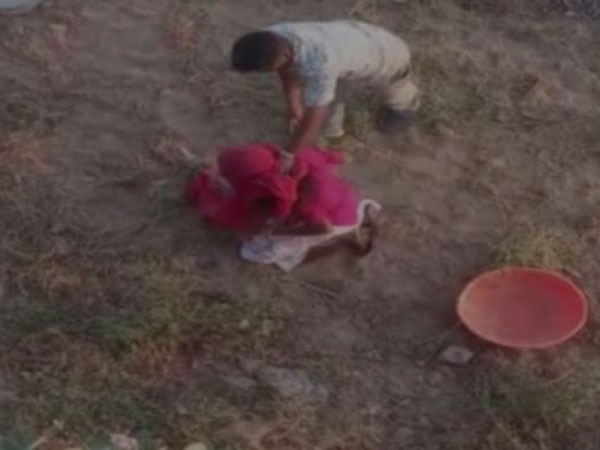 A grab of the video in which a man is beating up a woman in Barmer [Photo/ANI]