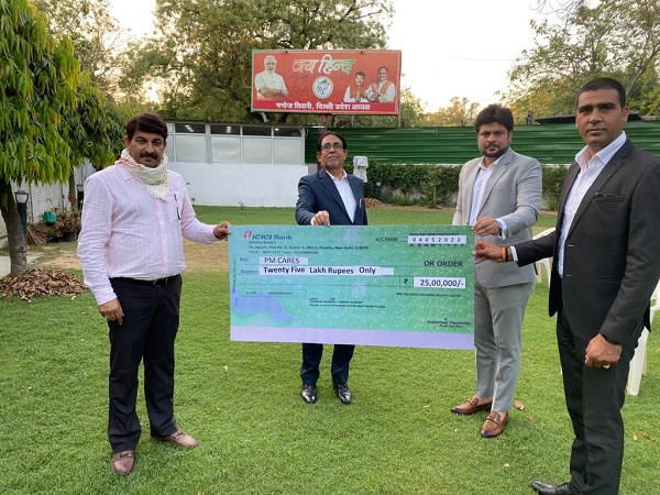 Sanjeev Kumar, Director - Asclepius Wellness Private Limited handing over the cheque to Manoj Tiwari, Member of Parliament