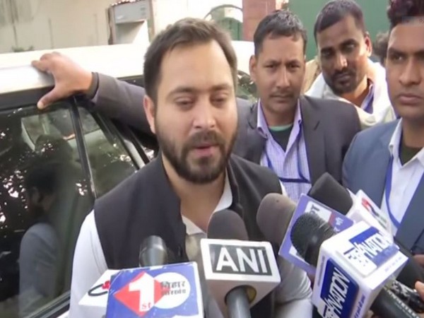 RJD leader Tejashwi Yadav talking to media persons in Patna on Tuesday (photo/ANI)