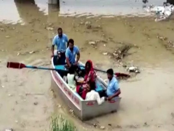 Delhi Disaster Management Authority rescuing a family of four from flood-hit area near Yamuna on Wednesday. (Photo/ANI) 