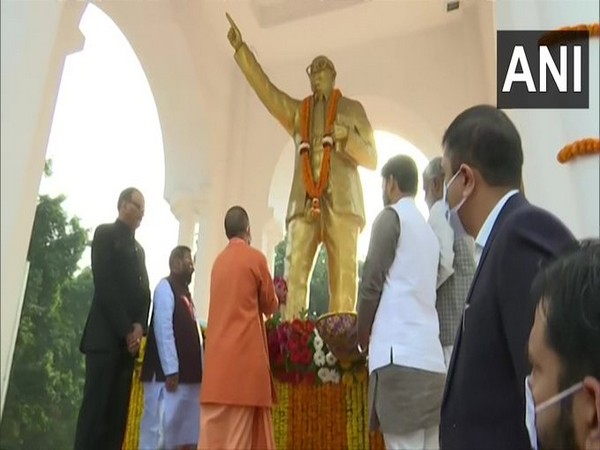 Uttar Pradesh Chief Minister Yogi Adityanath pays floral tribute to Dr BR Ambedkar (Photo/ANI)