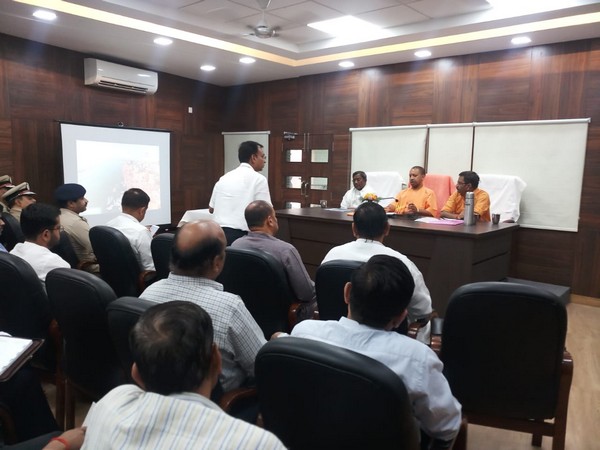 Uttar Pradesh chief minister Yogi Adityanath meeting with local administration officials in Varanasi on Sunday Photo/ANI.