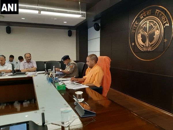 UP Chief Minister Yogi Adityanath holding a meeting with top brass in view of sudden spurt in crime against women in the state, in Lucknow on Monday. Photo/ANI