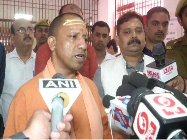 Uttar Pradesh Chief Minister Yogi Adityanath talking to reporters in Varanasi on Saturday. Photo/ANI